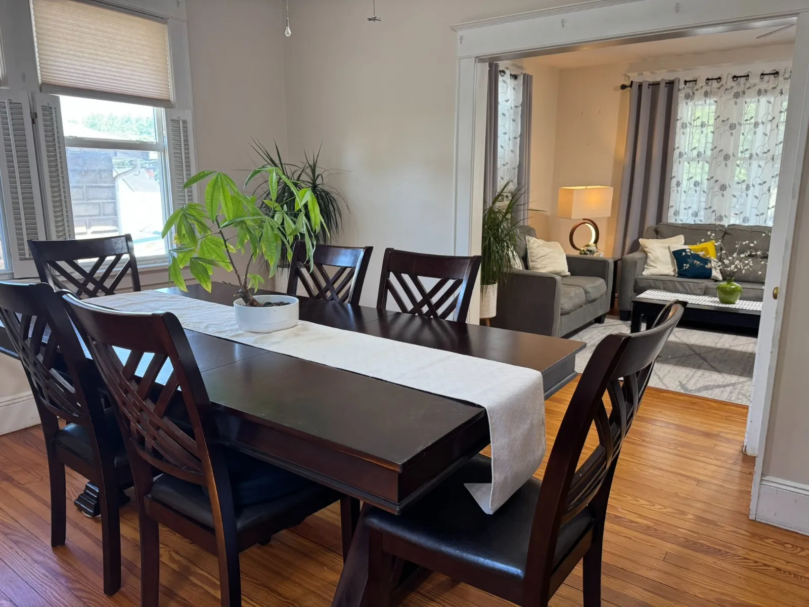 Dining room after restyling by Kultur & Decor: dining opening to living room (lamp + sofas); connector view.