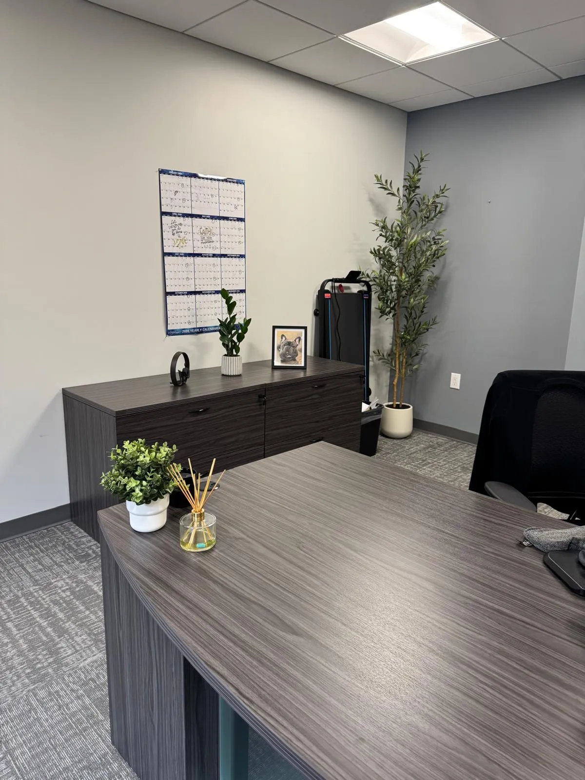Office after restyling by Kultur & Decor: calendar-wall corner styled (portrait alt angle).